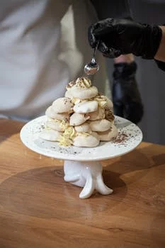 pastry chef decorating dessert carefully